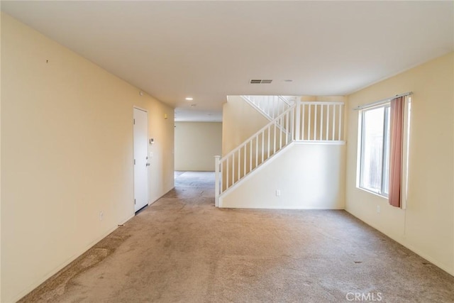 14051 Mare Ln, Victorville, CA 92394 - spare room featuring light carpet, stairs, and recessed lighting