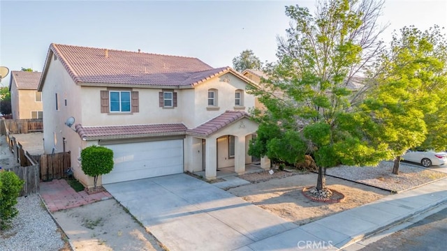 14051 Mare Ln, Victorville, CA 92394 - mediterranean / spanish house featuring a tiled roof, stucco siding, concrete driveway, and a garage