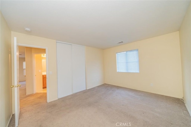 14051 Mare Ln, Victorville, CA 92394 - unfurnished bedroom with light colored carpet and a closet
