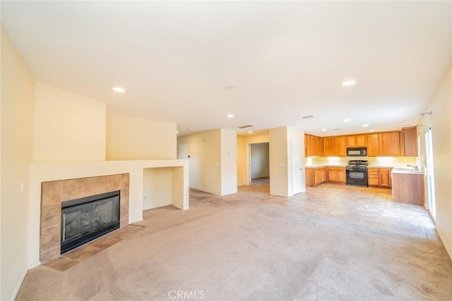 14051 Mare Ln, Victorville, CA 92394 - unfurnished living room with light colored carpet, a tile fireplace, and recessed lighting