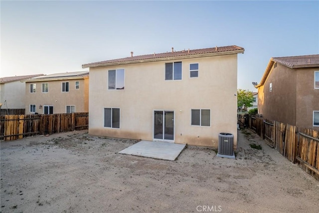 14051 Mare Ln, Victorville, CA 92394 - back of property featuring a fenced backyard, stucco siding, and a patio
