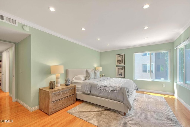 bedroom featuring visible vents, crown molding, light wood finished floors, and recessed lighting