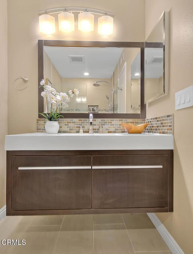 full bathroom featuring visible vents, walk in shower, vanity, and tasteful backsplash