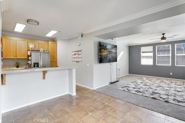 1441 Paseo Orion, San Diego, CA 92154 - kitchen featuring crown molding, stainless steel refrigerator with ice dispenser, tile counters, and open floor plan