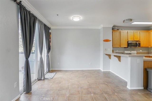 1441 Paseo Orion, San Diego, CA 92154 - kitchen featuring crown molding, baseboards, stainless steel microwave, and a breakfast bar