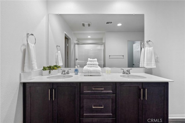 3308 Jack Rabbit Ct, Perris, CA 92570 - full bathroom with double vanity, visible vents, a stall shower, and a sink