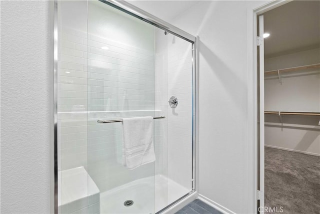 3308 Jack Rabbit Ct, Perris, CA 92570 - full bath featuring a walk in closet, baseboards, and a stall shower