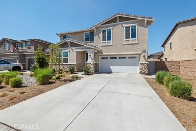 3308 Jack Rabbit Ct, Perris, CA 92570 - craftsman inspired home with driveway, stone siding, fence, a garage, and stucco siding