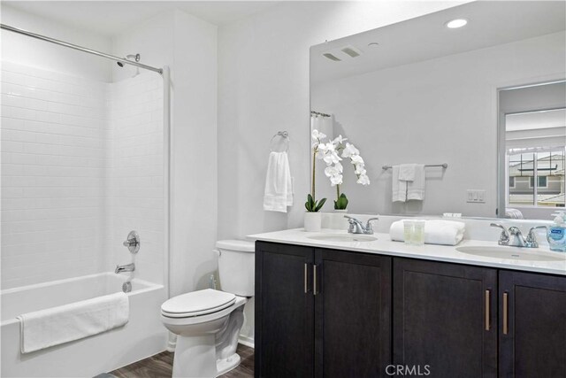 3308 Jack Rabbit Ct, Perris, CA 92570 - bathroom featuring wood finished floors, a sink, double vanity, and toilet