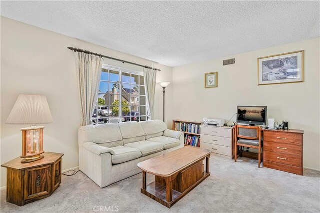 1426 Crestview Dr, Oceanside, CA 92056 - carpeted living room featuring a textured ceiling and a desk