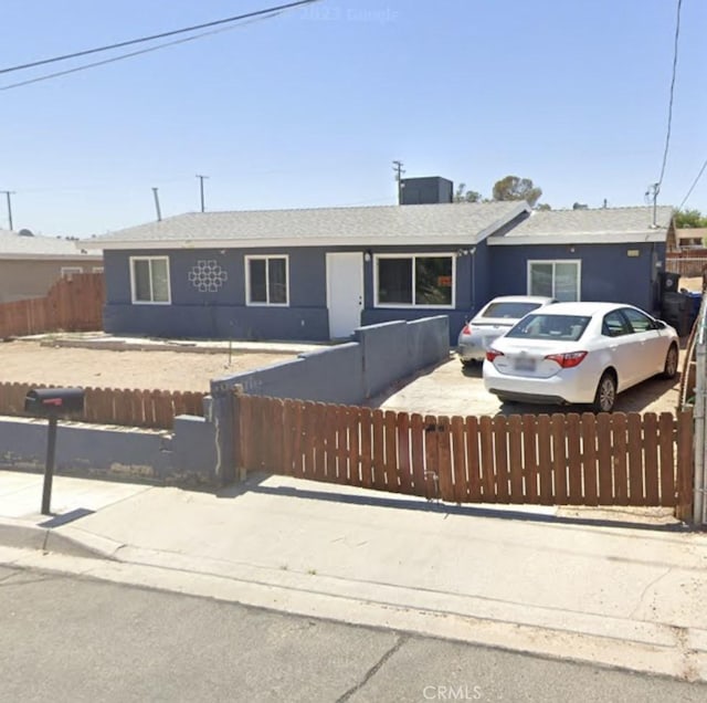 single story home with roof with shingles and a fenced front yard
