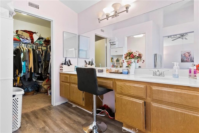 full bath featuring wood finished floors, visible vents, and vanity
