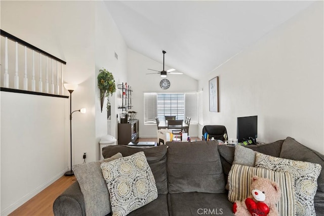 living room with visible vents, baseboards, a ceiling fan, wood finished floors, and high vaulted ceiling