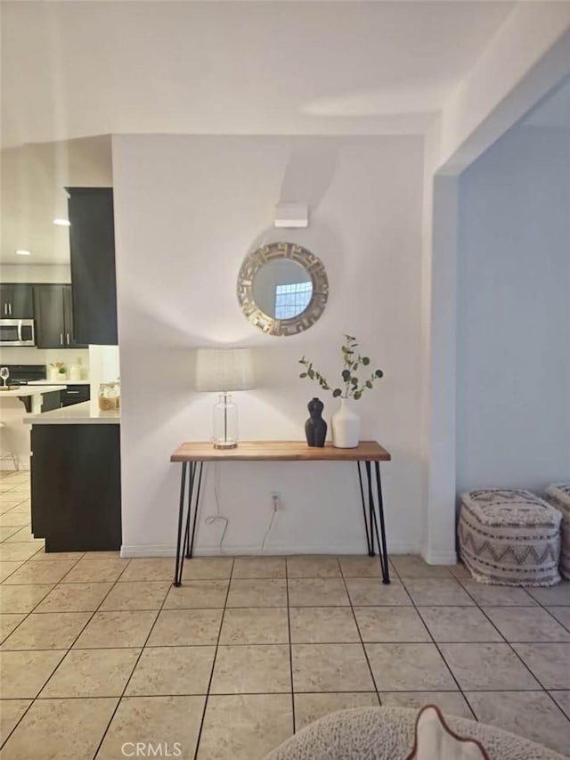 hall featuring light tile patterned flooring