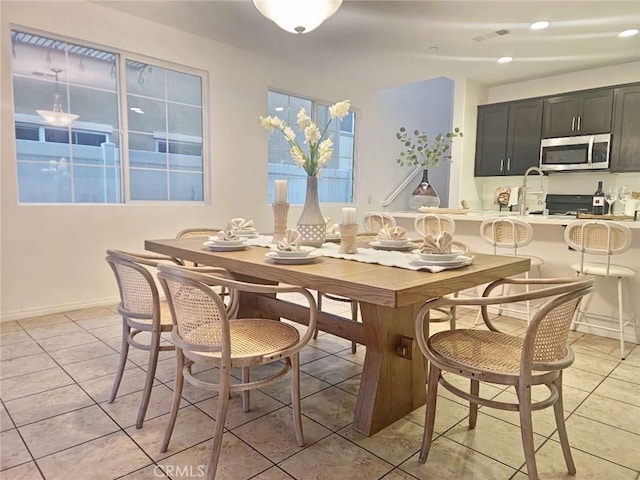 dining space with recessed lighting, baseboards, light tile patterned floors, and visible vents