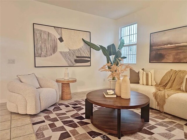 living area featuring baseboards and tile patterned floors