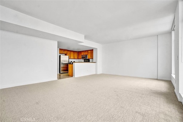 411 W Seaside Way Unit 1804, Long Beach, CA 90802 - unfurnished living room featuring light carpet and baseboards