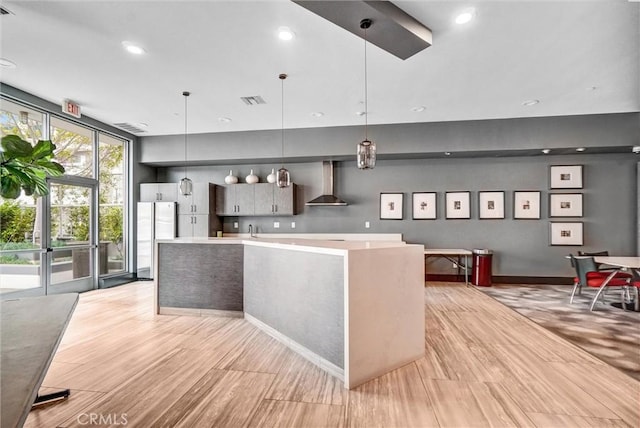 411 W Seaside Way Unit 1804, Long Beach, CA 90802 - kitchen featuring wall chimney exhaust hood, freestanding refrigerator, light countertops, floor to ceiling windows, and a large island