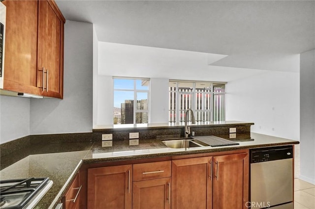 411 W Seaside Way Unit 1804, Long Beach, CA 90802 - kitchen featuring stainless steel appliances, a sink, brown cabinets, a peninsula, and light tile patterned floors