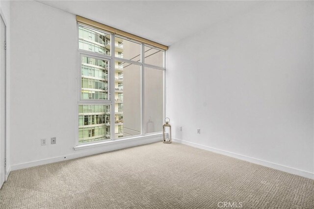 411 W Seaside Way Unit 1804, Long Beach, CA 90802 - carpeted empty room featuring healthy amount of natural light and baseboards