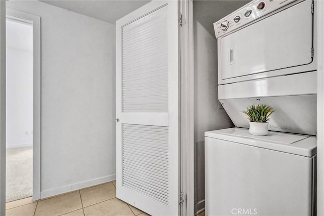 411 W Seaside Way Unit 1804, Long Beach, CA 90802 - washroom featuring stacked washer and clothes dryer, light tile patterned flooring, and baseboards