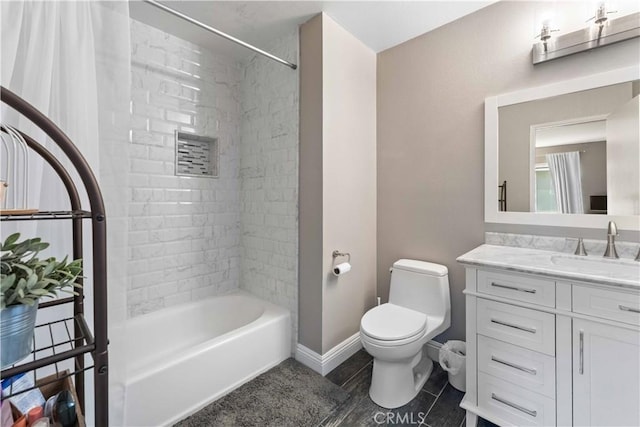 full bathroom with tile patterned floors, shower / bath combination, toilet, vanity, and baseboards