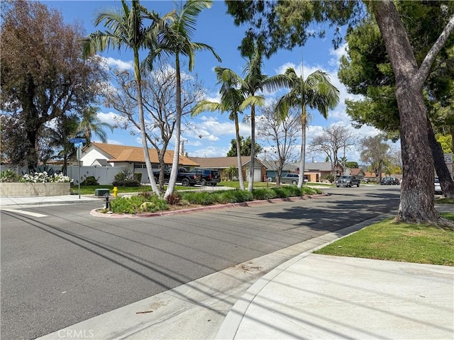 view of street featuring a residential view and curbs
