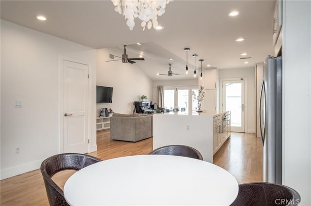 dining area featuring recessed lighting, light wood-style flooring, baseboards, and ceiling fan with notable chandelier