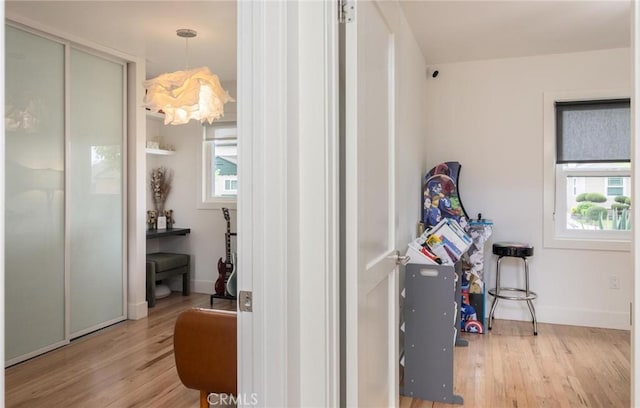 interior space with baseboards and wood finished floors