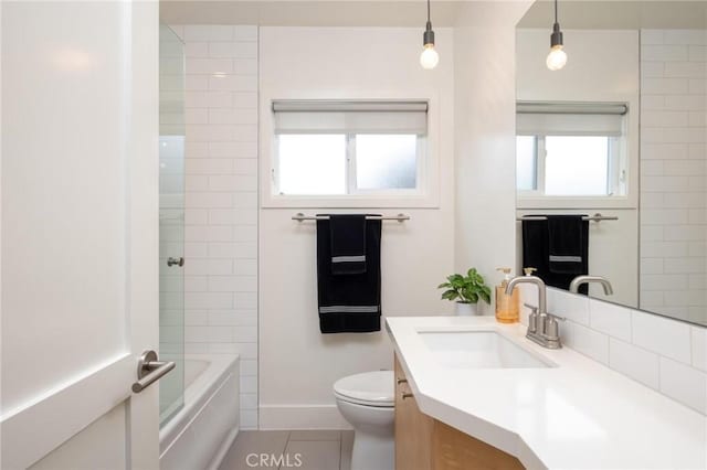 bathroom featuring tile patterned floors, shower / bathing tub combination, vanity, baseboards, and toilet