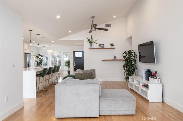 living room featuring recessed lighting, light wood-type flooring, baseboards, and ceiling fan