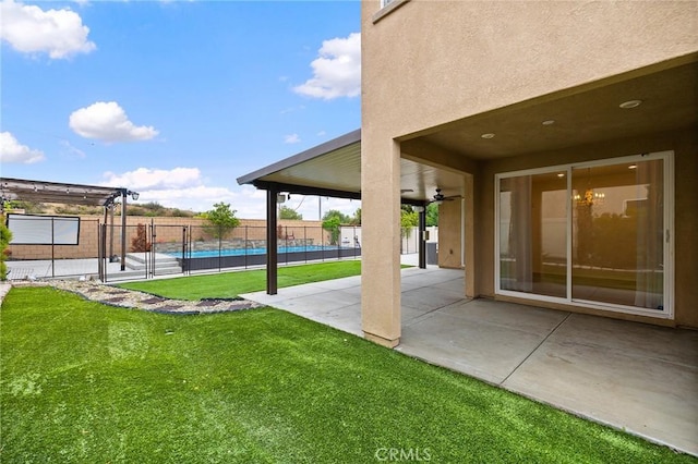 37544 River Oats Ln, Murrieta, CA 92563 - view of yard featuring ceiling fan, a fenced in pool, a patio, and fence
