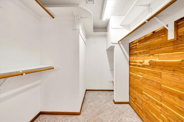 walk in closet featuring light colored carpet and visible vents