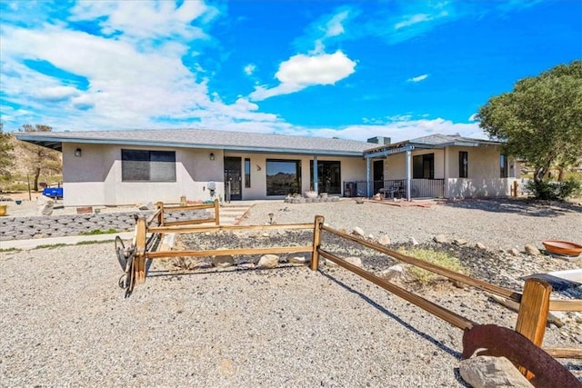 ranch-style house featuring stucco siding