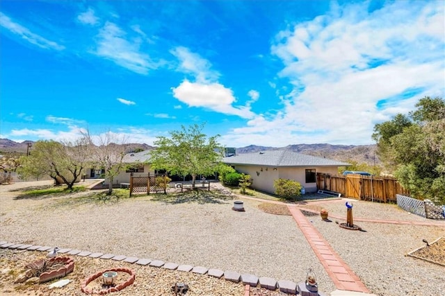 exterior space with a mountain view and fence