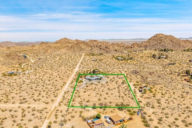 aerial view featuring a desert view, a mountain view, and a rural view