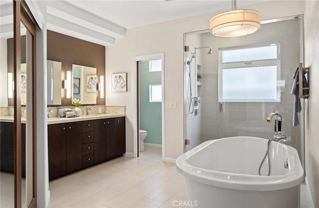 804 N Juanita Ave Unit B, Redondo Beach, CA 90277 - bathroom with a shower stall, double vanity, toilet, baseboards, and a freestanding tub