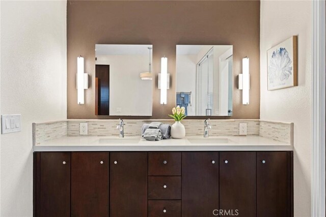 804 N Juanita Ave Unit B, Redondo Beach, CA 90277 - bathroom featuring a sink, double vanity, and tasteful backsplash
