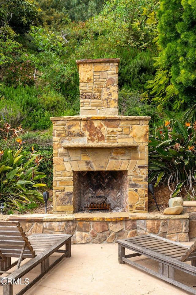 view of patio with an outdoor stone fireplace