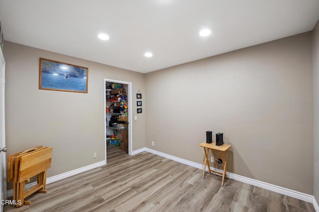 interior space featuring recessed lighting, baseboards, and light wood-style floors