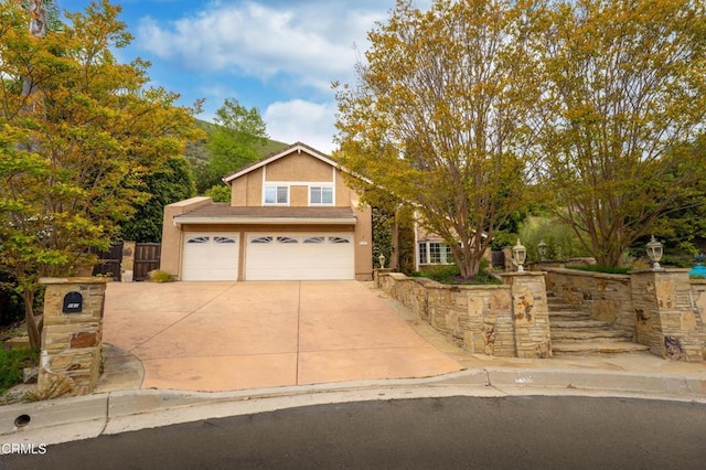 view of property hidden behind natural elements with fence, stucco siding, concrete driveway, and an attached garage