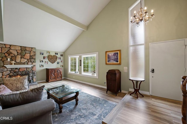living area with beam ceiling, a fireplace, a notable chandelier, high vaulted ceiling, and wood finished floors
