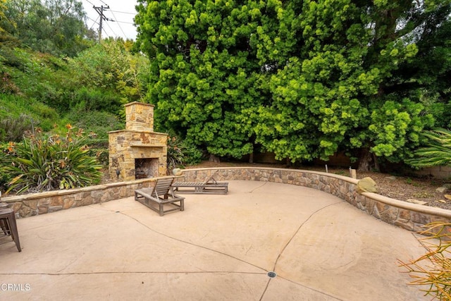 view of patio / terrace with an outdoor stone fireplace