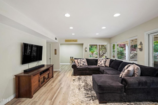 living area with recessed lighting, light wood-type flooring, and plenty of natural light