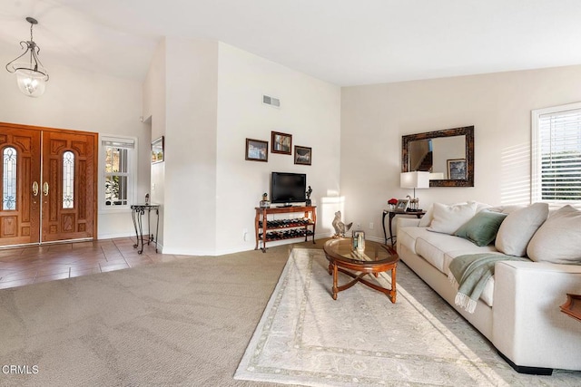1894 Rambling Rd, Simi Valley, CA 93065 - living room featuring carpet floors, a chandelier, a high ceiling, and tile patterned floors