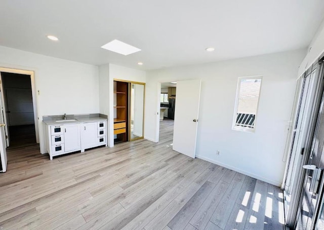 1025 Wilbur Ave, Pacific Beach San Diego, CA 92109 - unfurnished bedroom featuring a skylight, light wood-style flooring, a sink, and recessed lighting