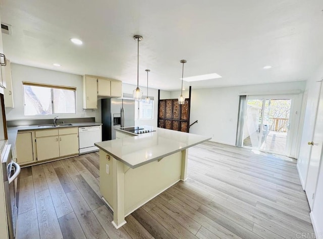 1025 Wilbur Ave, Pacific Beach San Diego, CA 92109 - kitchen featuring dishwasher, cream cabinetry, a sink, and a kitchen island