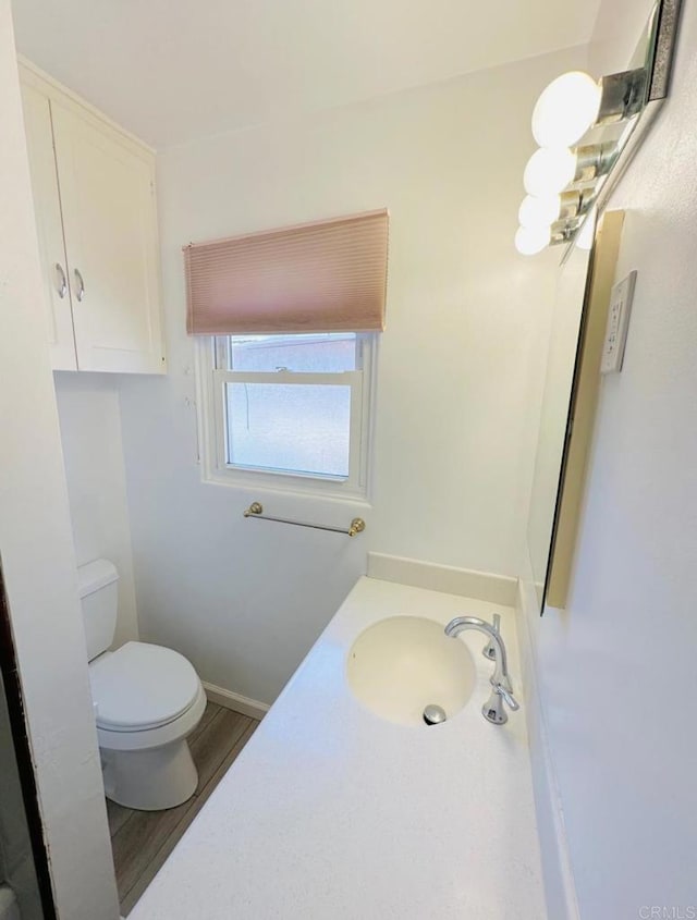 1025 Wilbur Ave, Pacific Beach San Diego, CA 92109 - bathroom with toilet, vanity, wood finished floors, and baseboards