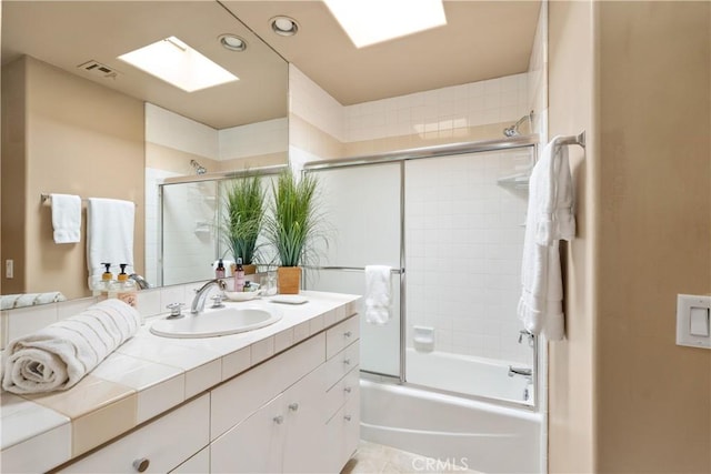 bathroom with visible vents, vanity, recessed lighting, enclosed tub / shower combo, and a skylight