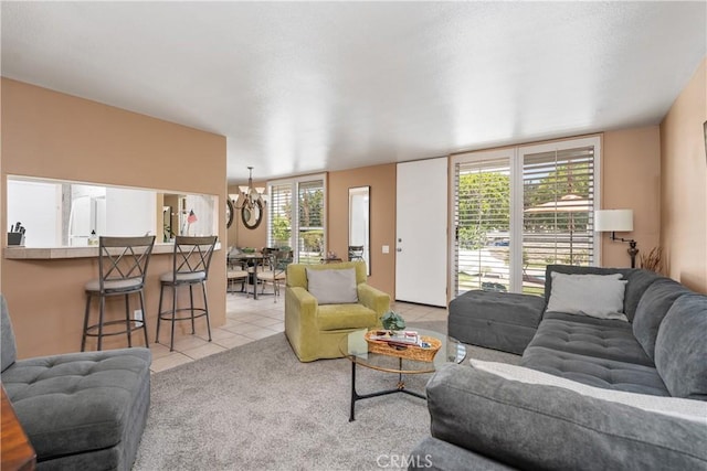 living room with a notable chandelier, light carpet, and light tile patterned floors